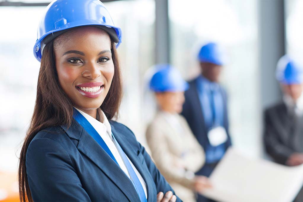 business women in blue hard hat smiling