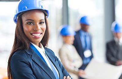 business women in blue hard hat smiling